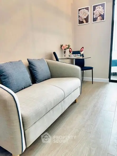 Stylish modern living room with cozy sofa and elegant dining area, perfect for urban living.