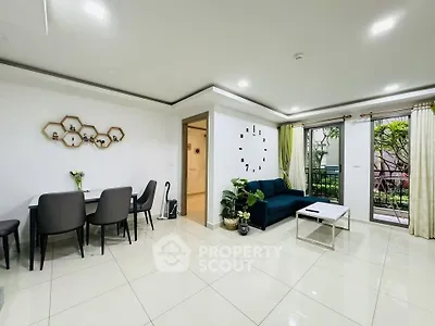Modern living room with stylish decor and garden view, featuring sleek furniture and elegant design.