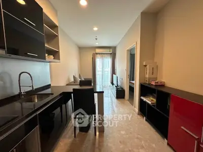 Modern kitchen with sleek black cabinets and open layout in a stylish apartment