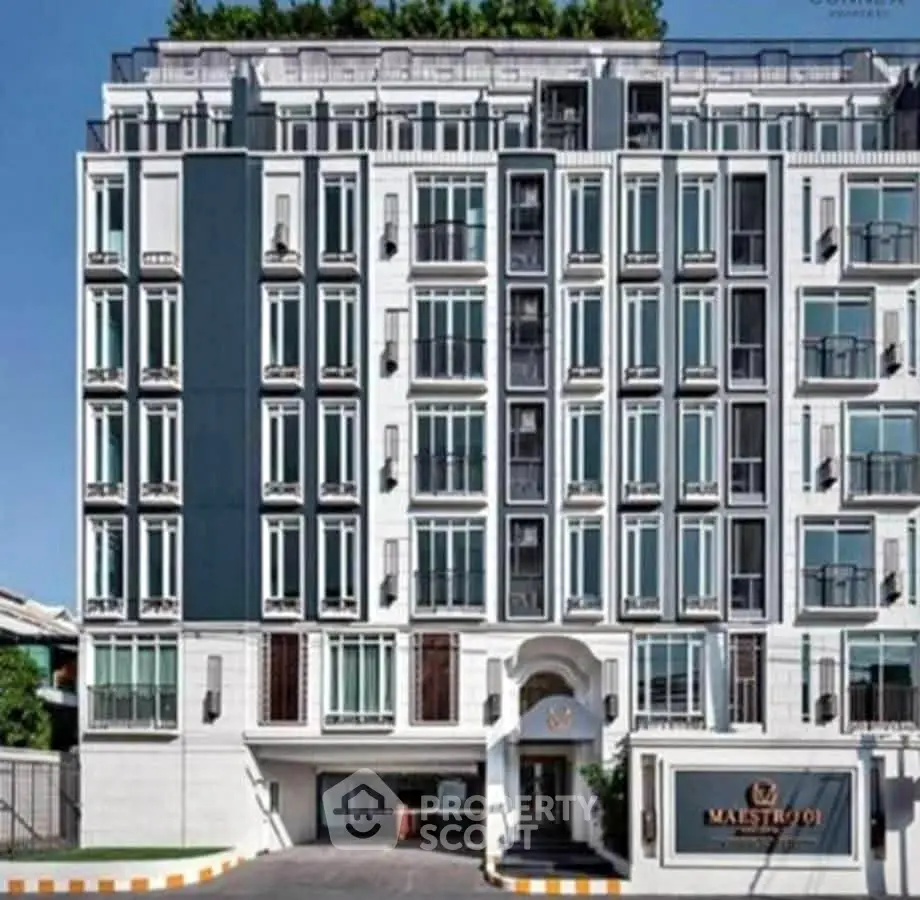 Elegant modern building exterior with multiple windows and stylish facade, perfect for urban living.