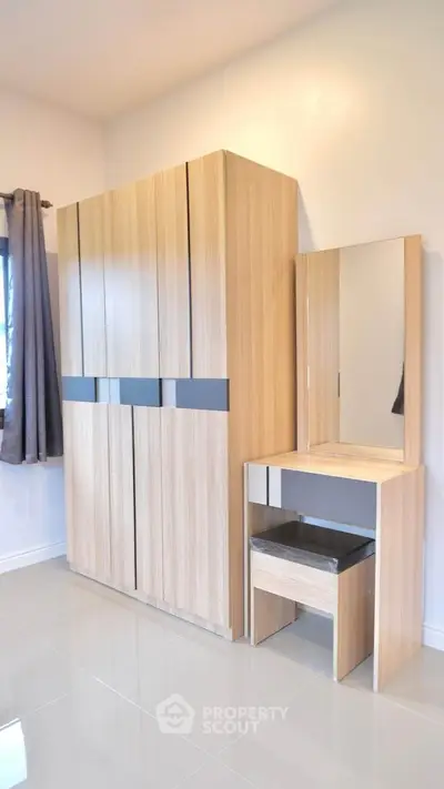 Modern bedroom with sleek wooden wardrobe and matching vanity set