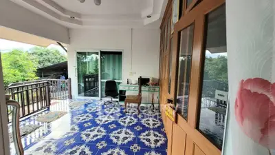 Spacious balcony with scenic view and stylish blue tile flooring, perfect for relaxation and outdoor enjoyment.
