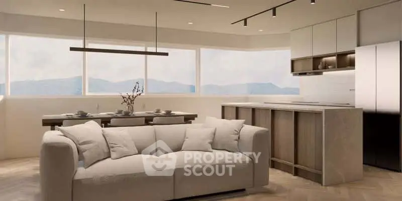 Modern open-plan living room and kitchen with mountain views, featuring sleek furniture and natural light.