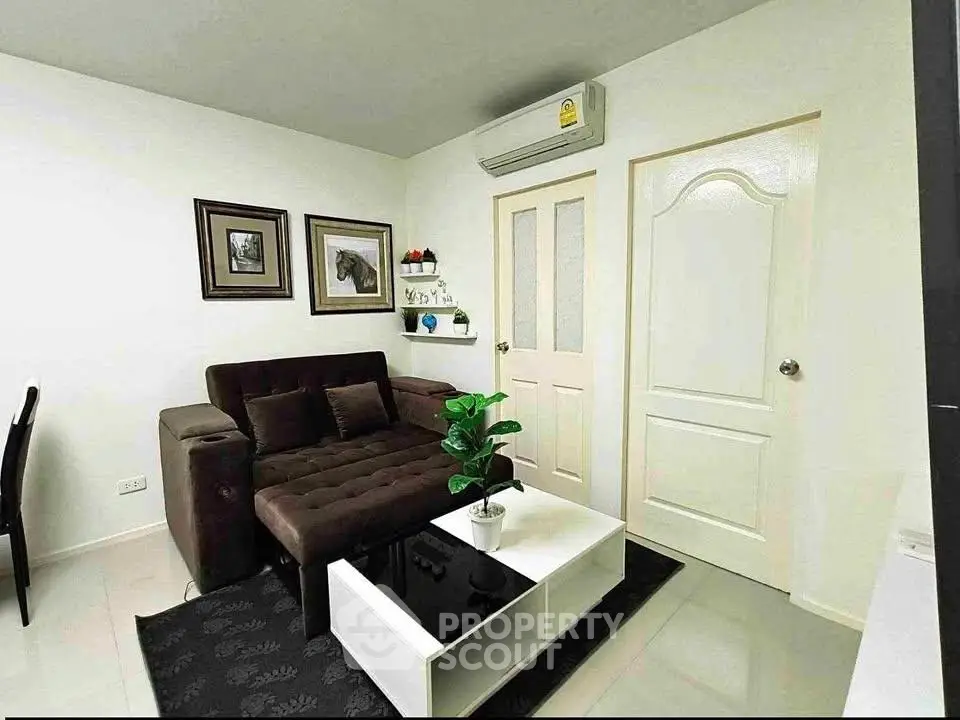 Cozy living room with modern decor and air conditioning in a stylish apartment.