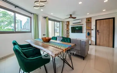 Modern living room with stylish furniture and large windows offering city views.