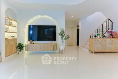 Spacious modern living room with elegant decor and large TV