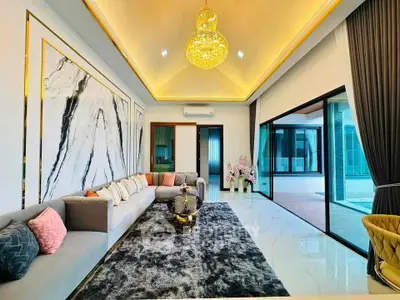 Luxurious living room with elegant decor and spacious layout, featuring a stunning chandelier and modern furnishings.