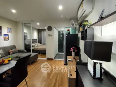 Modern apartment interior with open layout, featuring cozy living room and stylish kitchen.