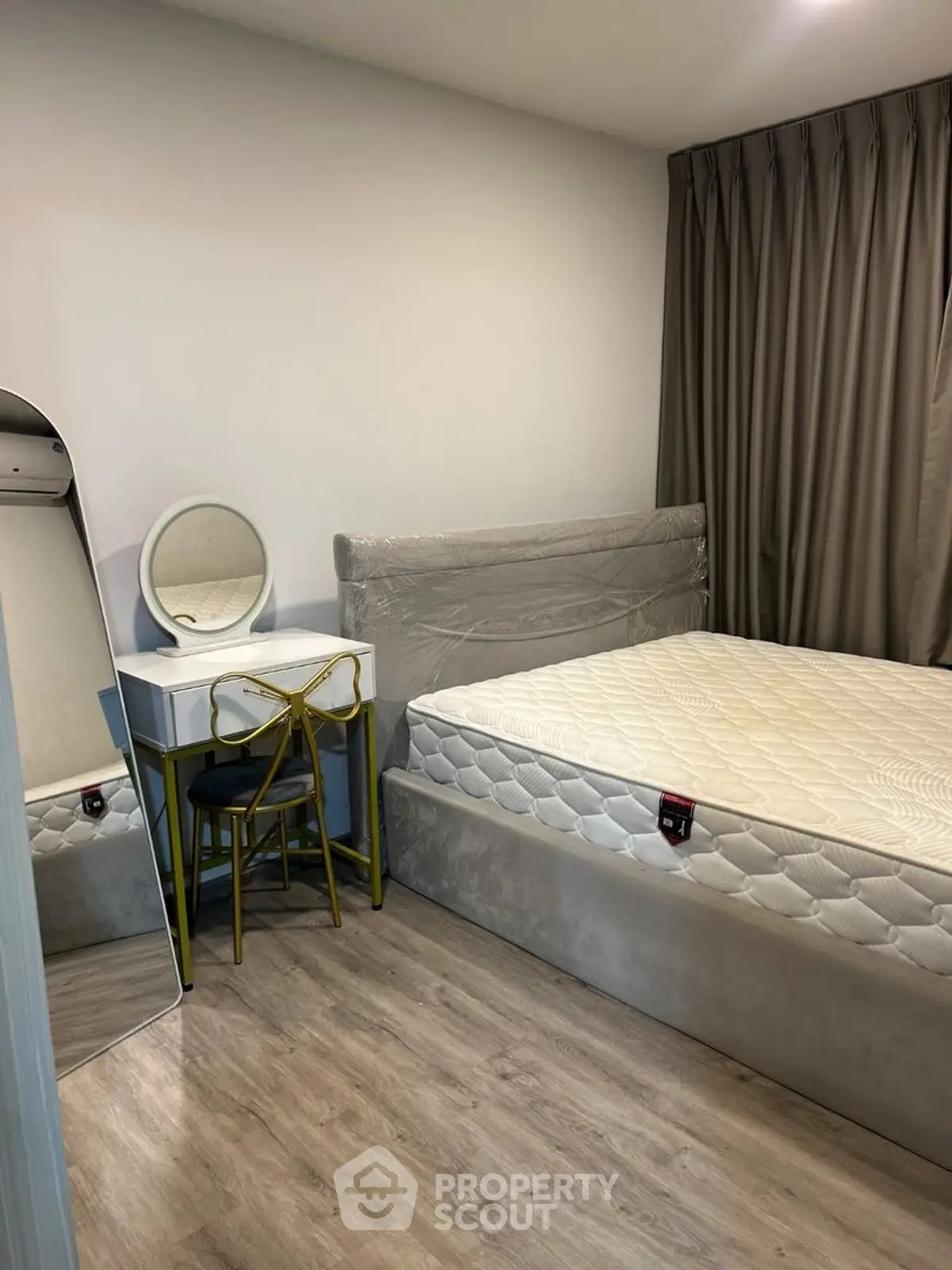 Cozy bedroom with modern furniture and elegant decor, featuring a comfortable bed and stylish vanity.