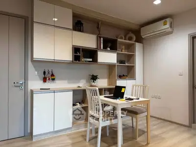 Modern study area with built-in shelves and air conditioning in a stylish apartment.
