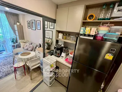 Cozy kitchen with modern appliances and open layout leading to a stylish living area.