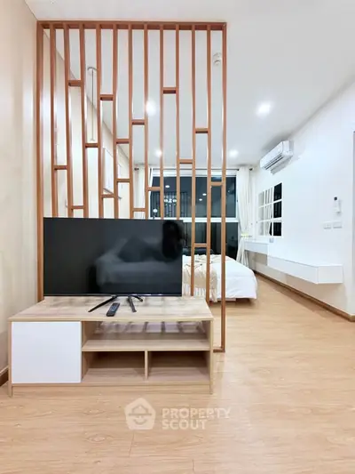 Modern studio apartment with wooden partition and sleek design