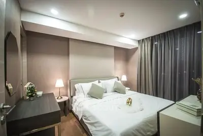 Cozy modern bedroom with elegant decor and soft lighting, perfect for relaxation.