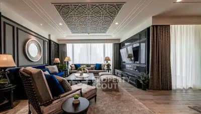 Luxurious living room with elegant decor, plush seating, and intricate ceiling design, perfect for sophisticated living.