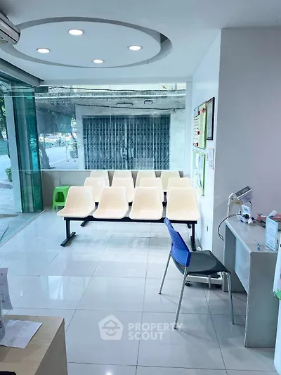 Modern waiting area with sleek seating and glass walls in a commercial space