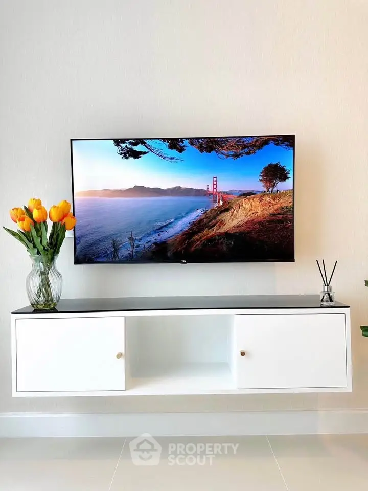 Modern living room with wall-mounted TV and stylish decor