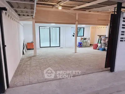 Spacious garage with ample storage space and sliding glass doors.