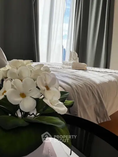 Luxurious bedroom with elegant decor and natural light, featuring plush bedding and stylish curtains.