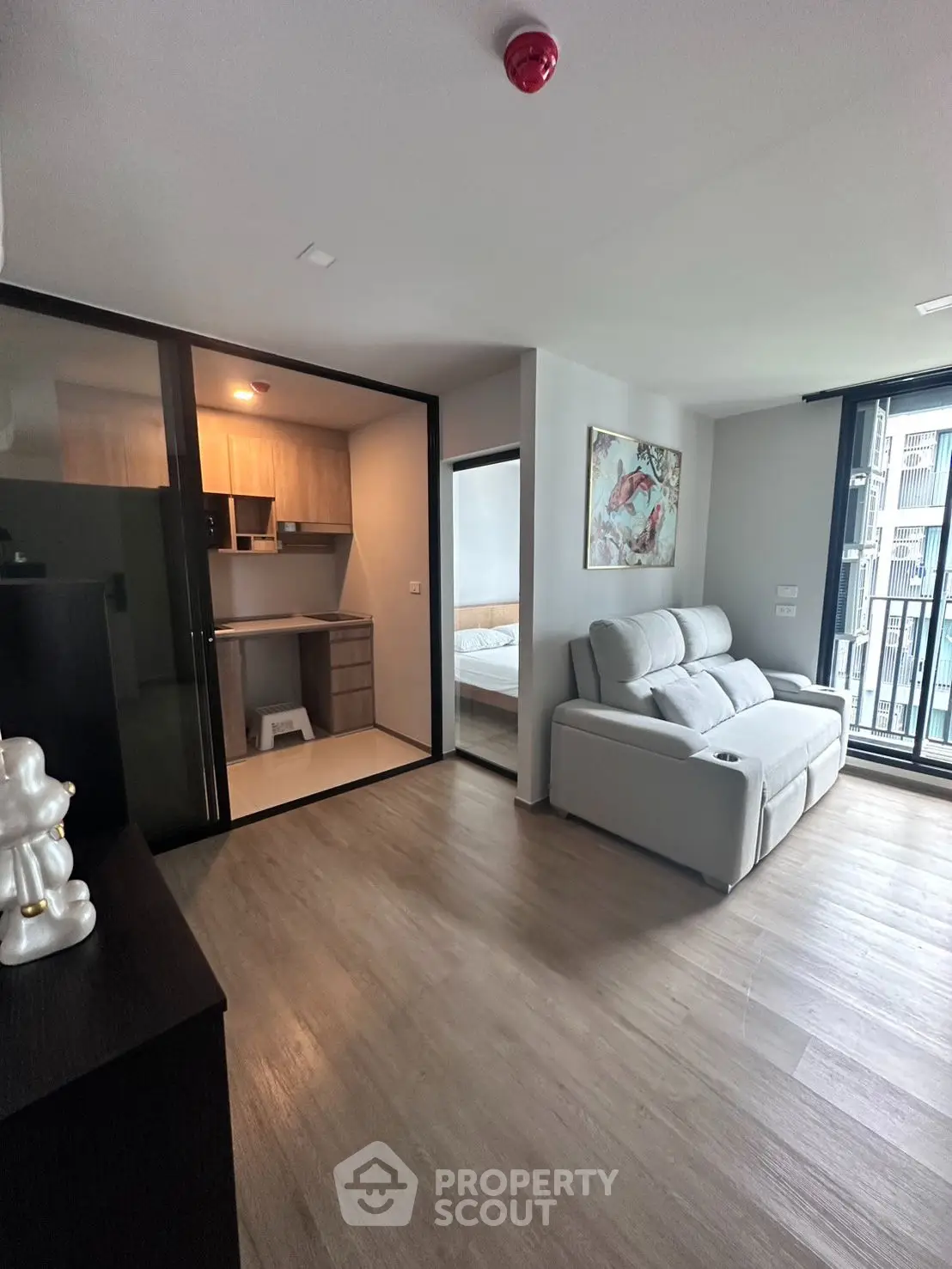 Modern apartment with open layout, featuring a cozy living room and stylish kitchen, perfect for urban living.