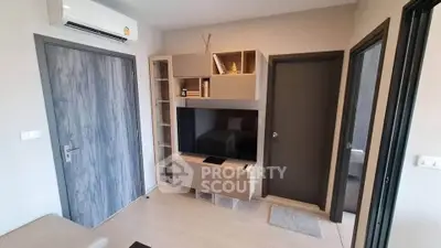 Modern living room with sleek TV unit and air conditioning in stylish apartment.