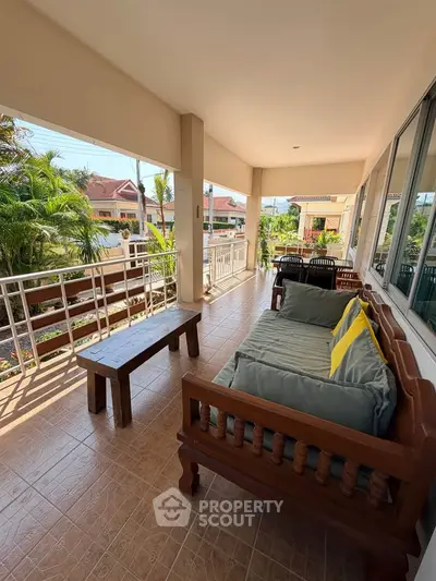 Spacious balcony with comfortable seating and scenic view in a serene neighborhood.