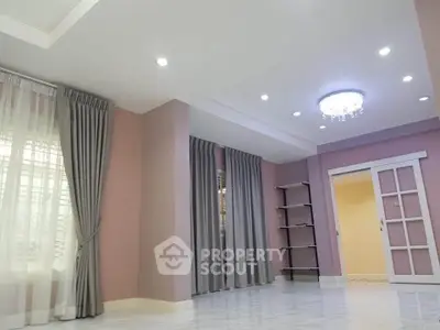 Spacious living room with elegant curtains and modern lighting