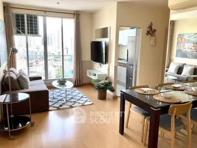 Modern open-plan living room with dining area and city view from balcony