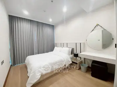 Modern bedroom with elegant decor and cozy ambiance, featuring a comfortable bed and stylish furnishings.