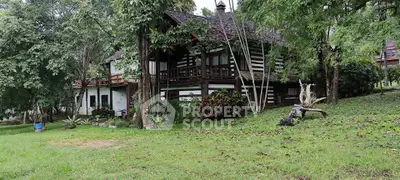 Charming rustic cabin surrounded by lush greenery, perfect for nature lovers seeking tranquility.