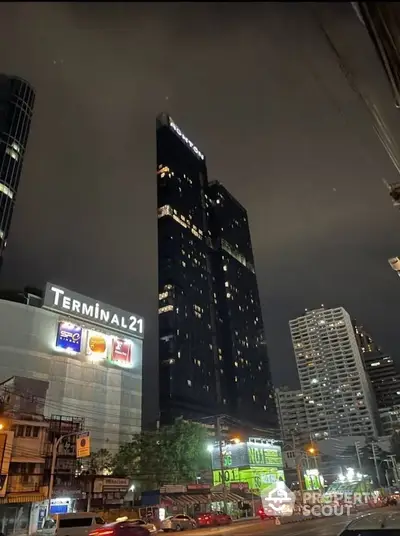 Stunning night view of modern high-rise buildings near Terminal 21, showcasing urban living.