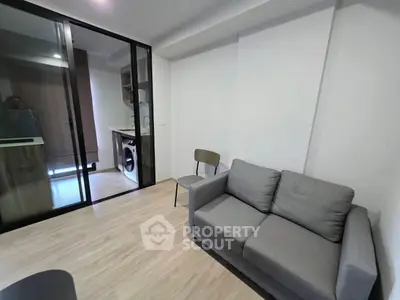 Modern living room with sleek design and compact kitchen area