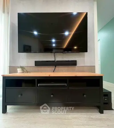Modern living room with sleek TV setup and stylish furniture