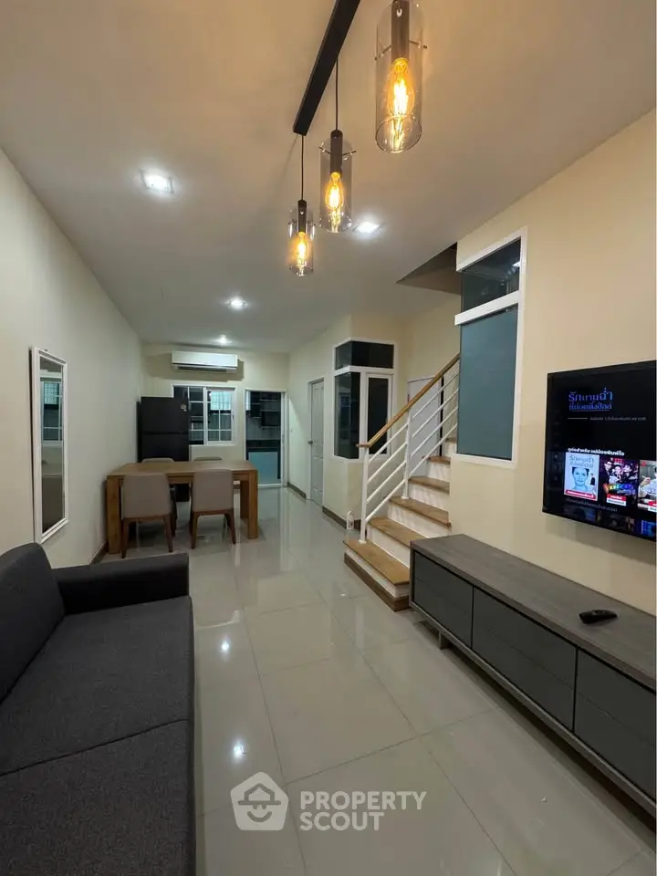 Modern living room with stylish lighting and sleek furniture in a contemporary home.