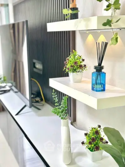Modern living room with stylish shelves and decor, featuring a sleek TV setup.
