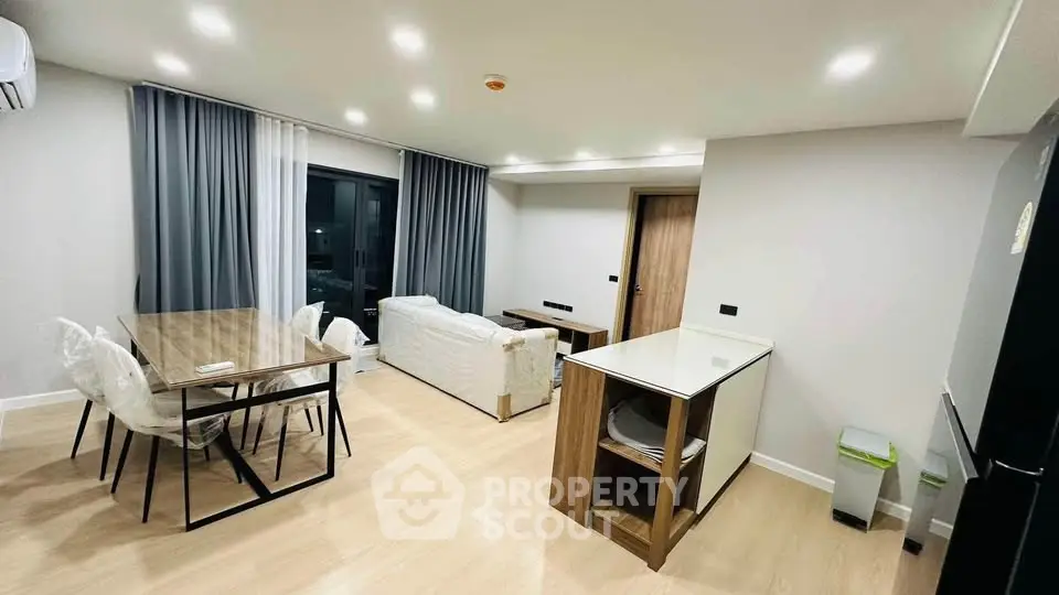 Modern open-layout living room with dining area and stylish furniture