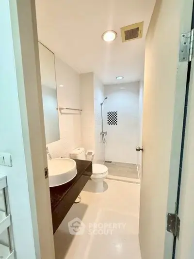 Modern bathroom with sleek fixtures and spacious shower area