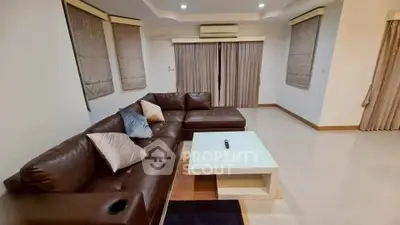 Spacious living room with modern leather sofa and elegant decor