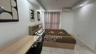 Modern bedroom with stylish decor and cozy ambiance, featuring a comfortable bed and sleek desk.