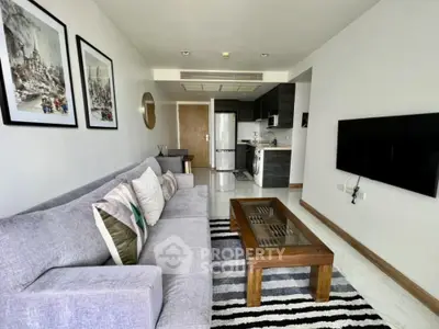 Modern living room with stylish decor and open kitchen layout in a contemporary apartment.