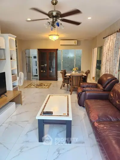 Spacious living room with leather sofa and elegant decor