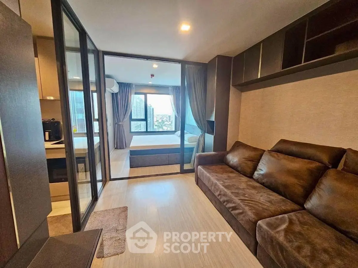 Modern condo interior with glass partition and cozy furnishings