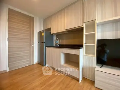 Modern compact kitchen with sleek wooden cabinets and integrated appliances