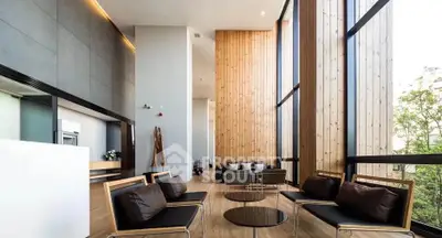 Luxurious modern living room with high ceilings and large windows offering stunning views.