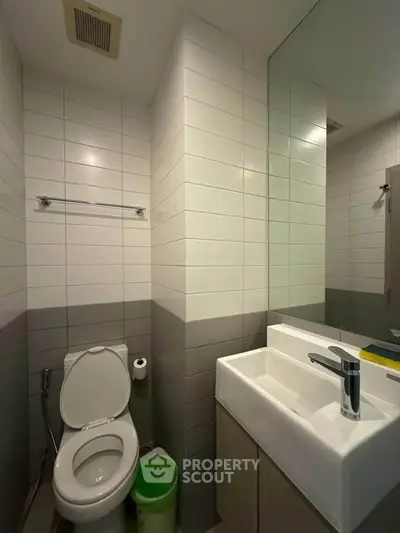 Modern bathroom with sleek white tiles and compact design