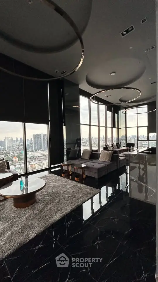 Luxurious high-rise living room with panoramic city views and modern decor.