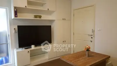 Cozy living room with built-in TV unit and wooden coffee table, perfect for relaxation.