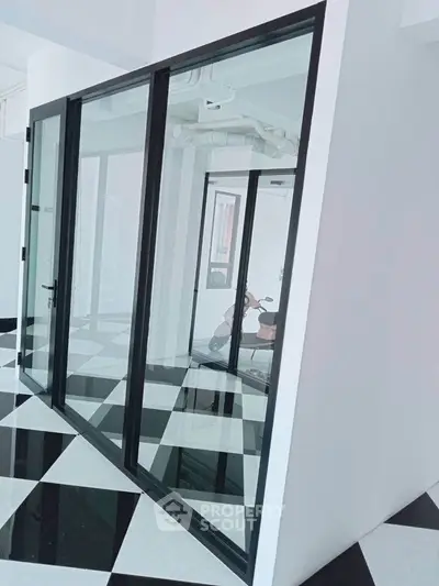Modern interior with glass walls and checkered floor tiles