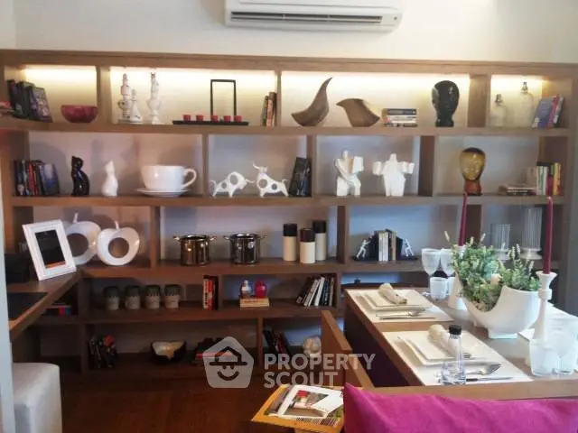 Stylish modern living room with decorative shelving and dining setup