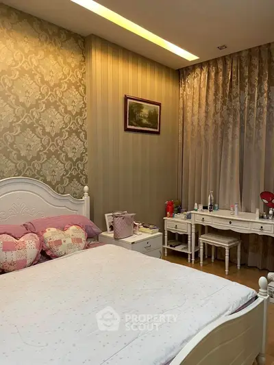 Charming bedroom with elegant wallpaper and cozy decor, perfect for relaxation and comfort.