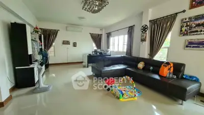 Spacious living room with modern decor and large windows for natural light.